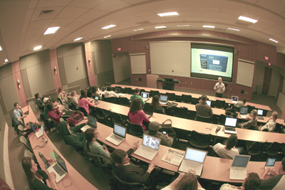 University hall with students, most of them with a tablet