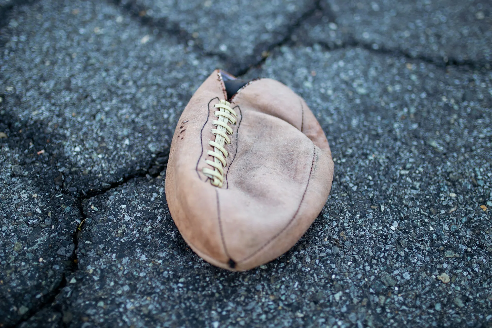 A deflated football that has been opened at one end.