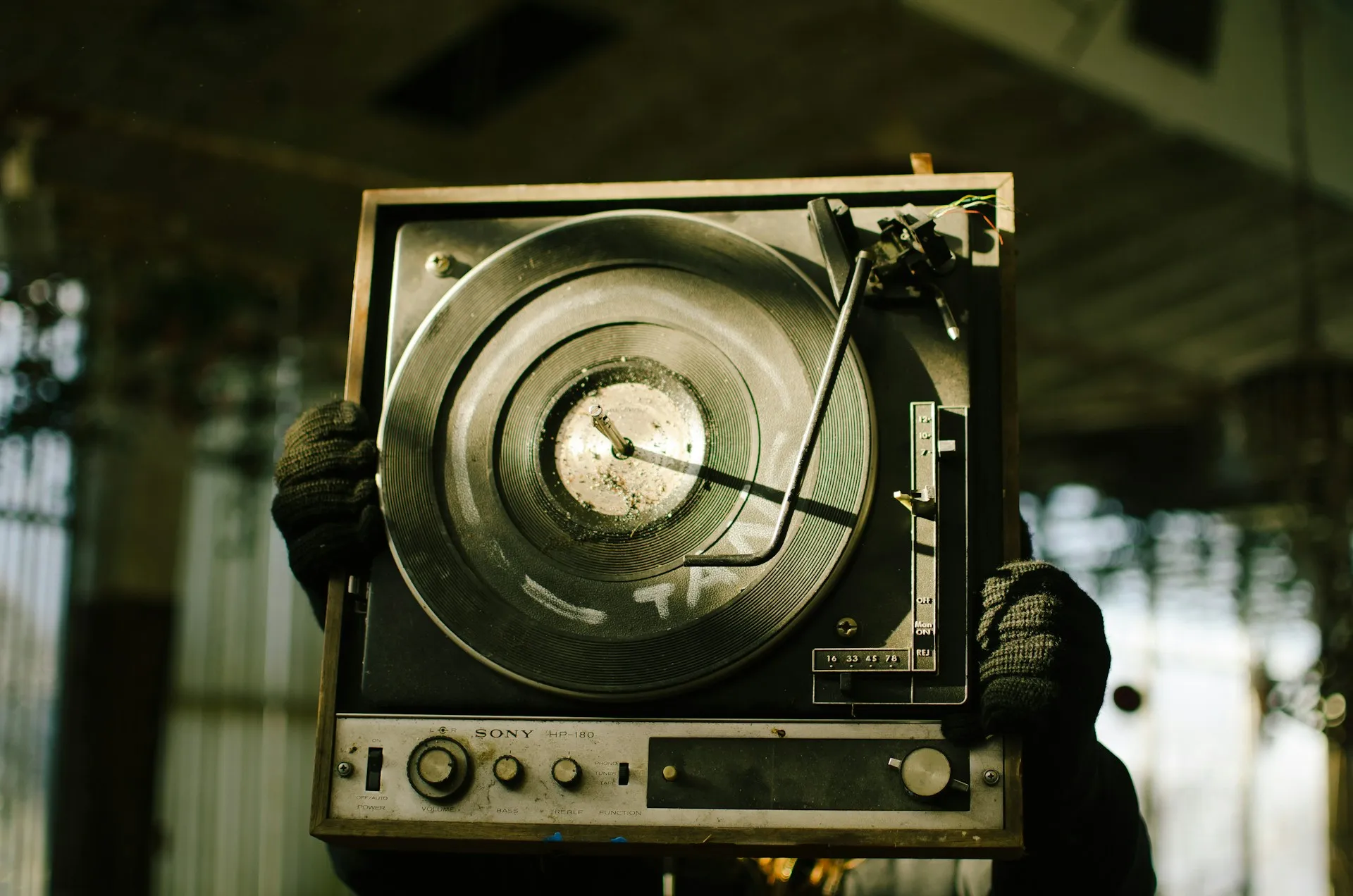 A record player with signs of wear, missing various components.